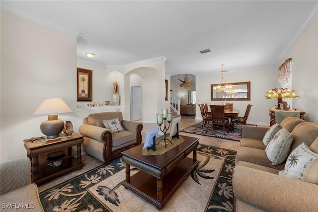 living area featuring arched walkways, a chandelier, crown molding, and stairs