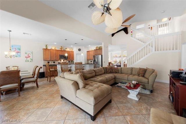 living room featuring a chandelier, a ceiling fan, stairway, and light tile patterned floors