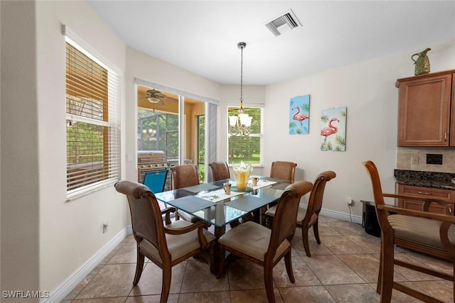 dining room featuring baseboards and light tile patterned flooring