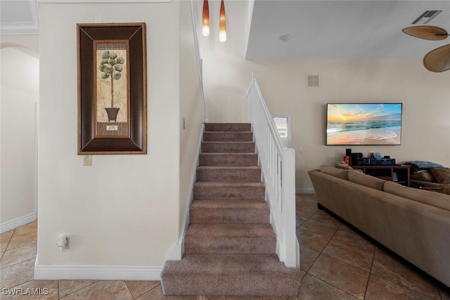 stairway featuring tile patterned flooring and baseboards