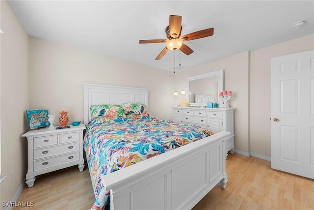 bedroom with light wood-style flooring, baseboards, and ceiling fan