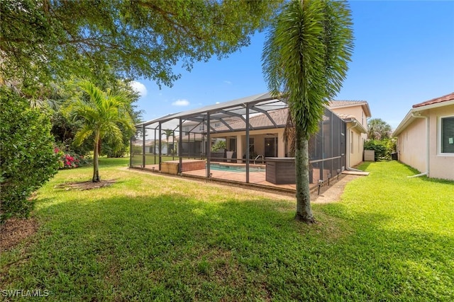 back of property with a yard, an outdoor pool, and glass enclosure