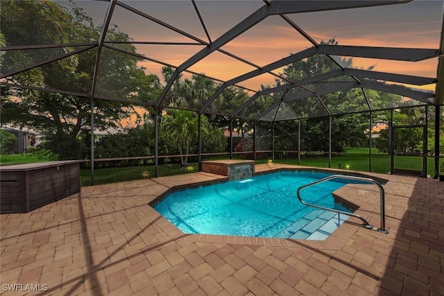 swimming pool featuring a patio and glass enclosure