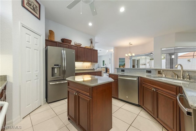 4081 Marianne Key Rd, Punta Gorda, FL 33955 - kitchen with stainless steel appliances, a sink, ceiling fan, hanging light fixtures, and light tile patterned floors
