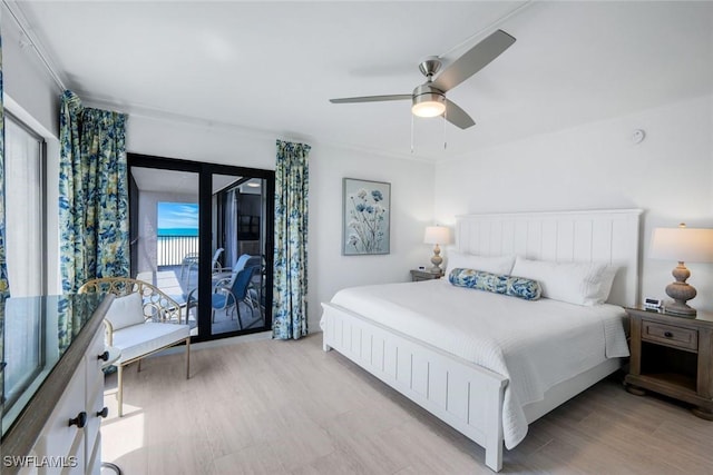 bedroom featuring access to exterior, wood finished floors, and ceiling fan