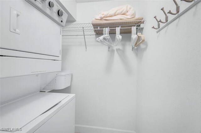 walk in closet featuring stacked washer and clothes dryer