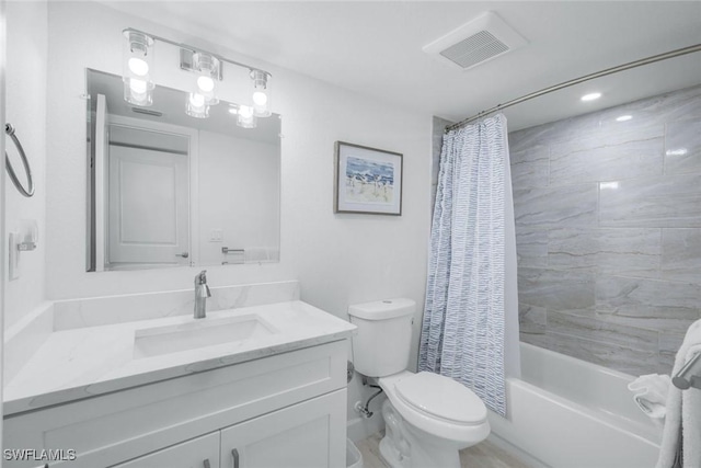 bathroom featuring toilet, vanity, and shower / bath combo