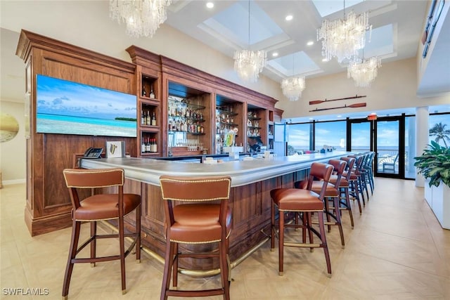 community bar area featuring a chandelier, coffered ceiling, a towering ceiling, recessed lighting, and beam ceiling