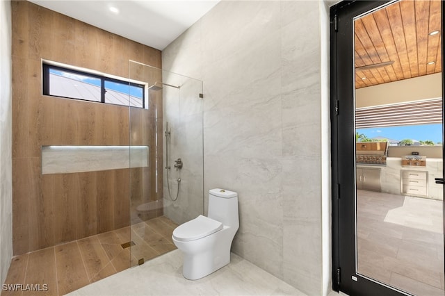3413 NW 9th Ter, Cape Coral, FL 33993 - bathroom with a walk in shower, toilet, and tile walls