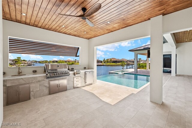 3413 NW 9th Ter, Cape Coral, FL 33993 - view of pool featuring a sink, ceiling fan, a pool with connected hot tub, a patio area, and a water view