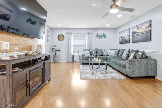 2809 50th St SW, Naples, FL 34116 - living area featuring light wood-style floors, ceiling fan, baseboards, a textured ceiling, and recessed lighting