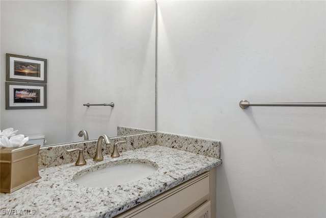 half bathroom featuring vanity and toilet