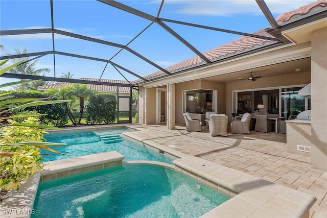 view of pool with a patio, a pool with connected hot tub, ceiling fan, and glass enclosure