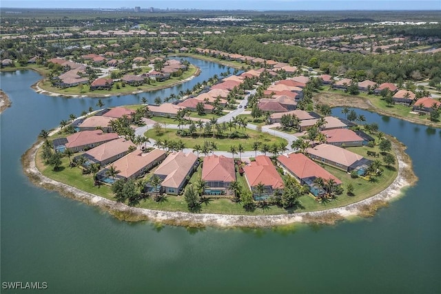 aerial view of property and surrounding area featuring nearby suburban area and a large body of water