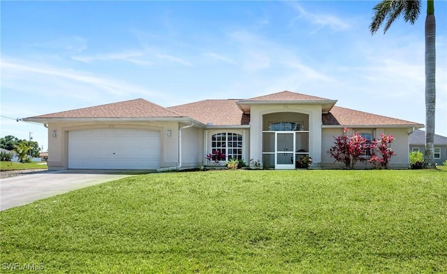 single story home with stucco siding, a garage, and a front yard