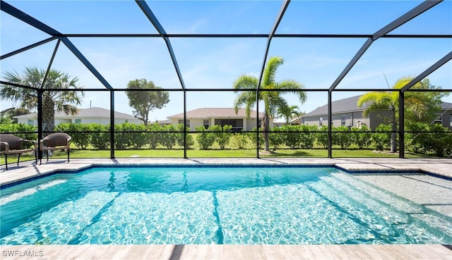 outdoor pool with a lanai and a patio area