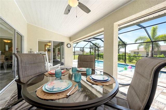 sunroom with outdoor dining space, ceiling fan, lofted ceiling, and a pool