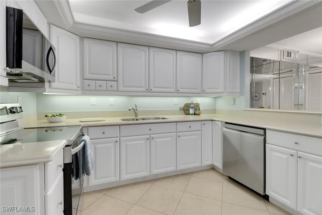3399 Gulf Shore Blvd N Unit 303, Naples, FL 34103 - kitchen with stainless steel appliances, a sink, white cabinetry, and light countertops