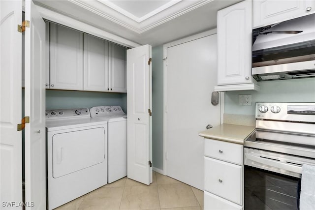 3399 Gulf Shore Blvd N Unit 303, Naples, FL 34103 - laundry room featuring cabinet space, washer and clothes dryer, and light tile patterned floors