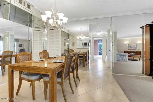 3399 Gulf Shore Blvd N Unit 303, Naples, FL 34103 - dining area with a chandelier, ornamental molding, light tile patterned floors, and light carpet