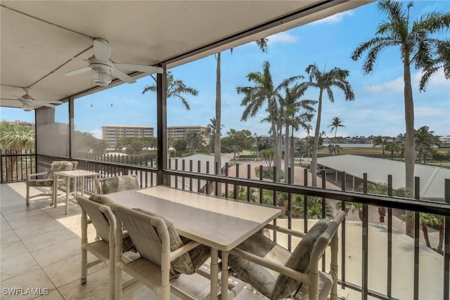 3399 Gulf Shore Blvd N Unit 303, Naples, FL 34103 - balcony with a ceiling fan and outdoor dining area