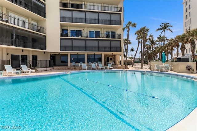 3399 Gulf Shore Blvd N Unit 303, Naples, FL 34103 - community pool featuring a patio