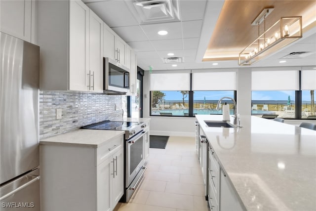 3399 Gulf Shore Blvd N Unit 303, Naples, FL 34103 - kitchen with stainless steel appliances, a sink, tasteful backsplash, plenty of natural light, and recessed lighting