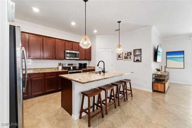 9519 Foxglove Ln, Naples, FL 34120 - kitchen with stainless steel appliances, a sink, crown molding, light stone countertops, and a breakfast bar