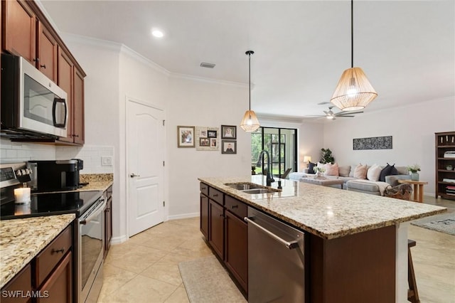 9519 Foxglove Ln, Naples, FL 34120 - kitchen with appliances with stainless steel finishes, a sink, a ceiling fan, crown molding, and backsplash