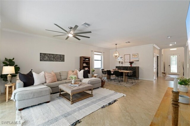 9519 Foxglove Ln, Naples, FL 34120 - living area with crown molding, a ceiling fan, baseboards, light tile patterned floors, and a chandelier