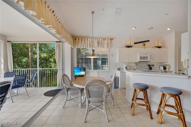 25224 Pelican Creek Cir Unit 203, Bonita Springs, FL 34134 - dining room with light tile patterned floors and recessed lighting