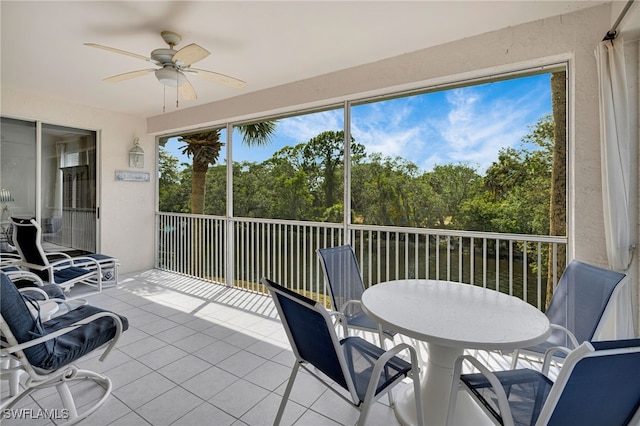 25224 Pelican Creek Cir Unit 203, Bonita Springs, FL 34134 - sunroom featuring a ceiling fan, outdoor dining area, and view of wooded area