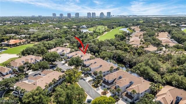 25224 Pelican Creek Cir Unit 203, Bonita Springs, FL 34134 - aerial view of property's location featuring a local golf course, a nearby body of water, and nearby suburban area