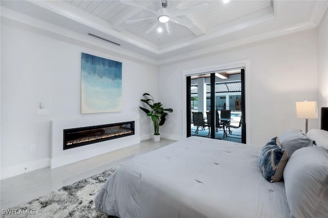 333 12th Ave NE, Naples, FL 34120 - bedroom with a glass covered fireplace, baseboards, concrete flooring, beam ceiling, and access to exterior