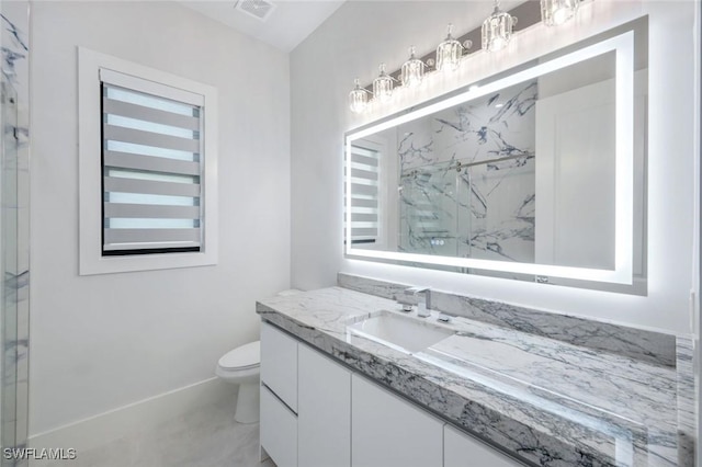 333 12th Ave NE, Naples, FL 34120 - bathroom with vanity, toilet, a marble finish shower, and baseboards
