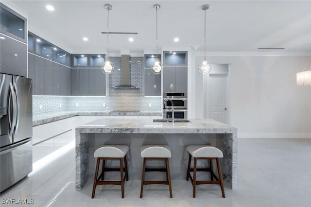 333 12th Ave NE, Naples, FL 34120 - kitchen featuring appliances with stainless steel finishes, wall chimney exhaust hood, modern cabinets, backsplash, and recessed lighting