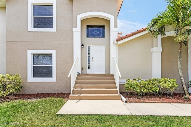 property entrance with stucco siding