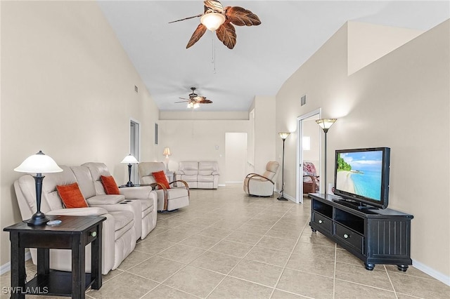 living room featuring a ceiling fan, light tile patterned floors, baseboards, and vaulted ceiling