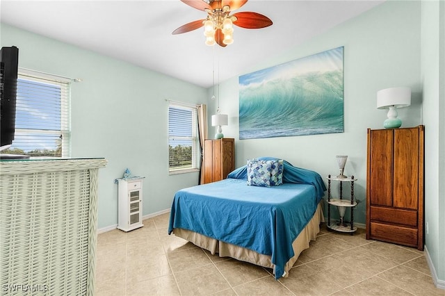 bedroom featuring multiple windows, light tile patterned floors, and baseboards