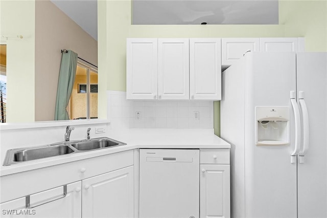 kitchen featuring white appliances, a sink, white cabinetry, light countertops, and backsplash