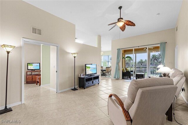 living area with ceiling fan, light tile patterned floors, and baseboards