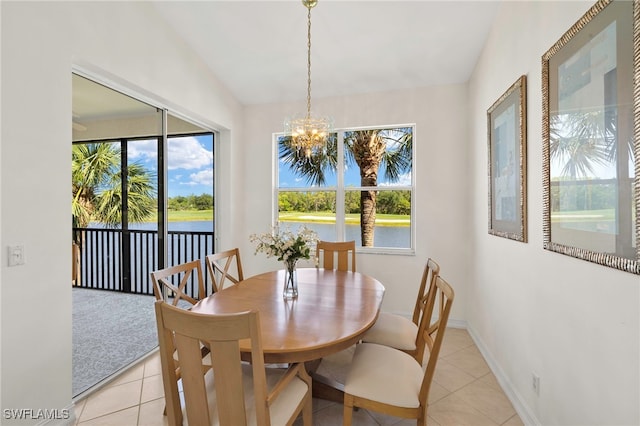 21551 Pelican Sound Dr Unit 202, Estero, FL 33928 - dining area with a chandelier, vaulted ceiling, a water view, light tile patterned floors, and baseboards