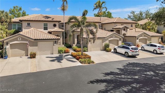 21551 Pelican Sound Dr Unit 202, Estero, FL 33928 - mediterranean / spanish house featuring a tiled roof, stucco siding, and driveway