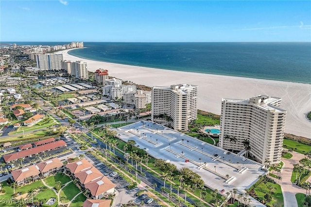 view of urban area featuring waterfront with a beach