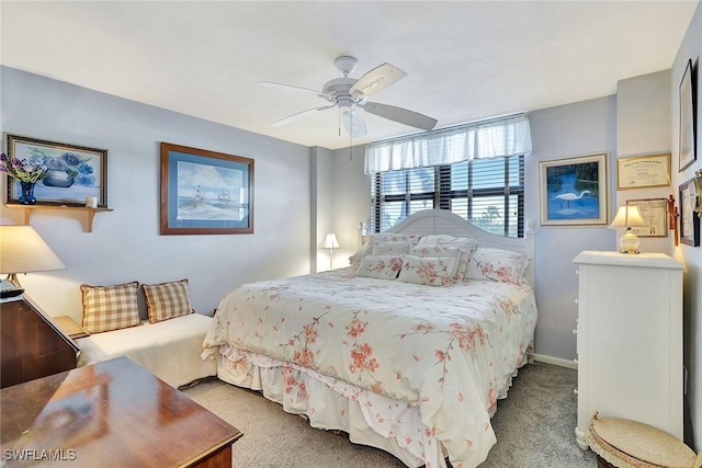 carpeted bedroom featuring baseboards and a ceiling fan
