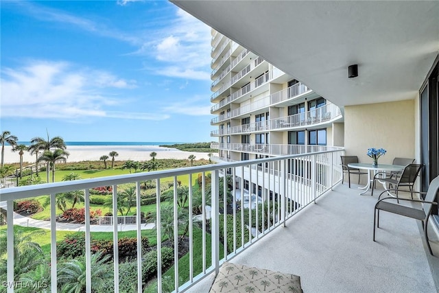balcony with view of water and beach
