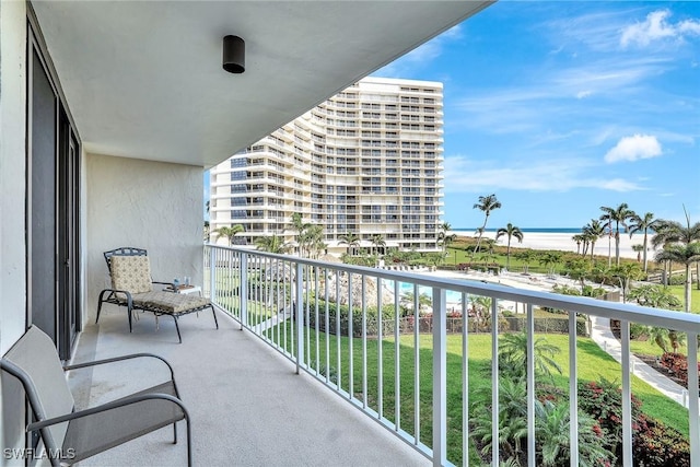 balcony with view of water and beach