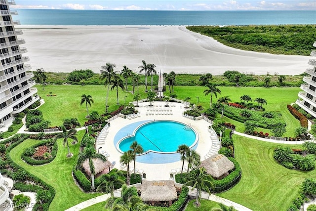 drone / aerial view of a pool area and a large body of water