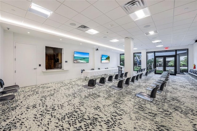 miscellaneous room with a drop ceiling and carpet flooring