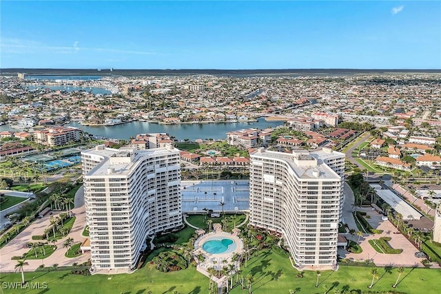 aerial overview of property's location featuring a nearby body of water and a pool